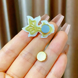 Detailed macro view of goldfish magnetic brooch with shell inlay and strong magnet back