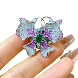 Magnetic butterfly brooch with cubic zirconia and green gemstone on silver base