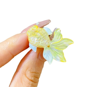 Elegant shell-textured goldfish brooch with soft pearlescent finish and detailed tail