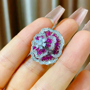 Elegant floral magnetic ring with red zircon and sparkling crystals on hand