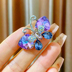 Exquisite butterfly brooch with purple heart crystals and blue teardrop stones on silver frame