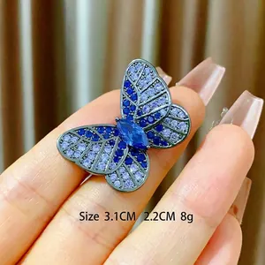 Elegant butterfly brooch with blue zircon stones and dark metal finish, size 3.1cm x 2.2cm