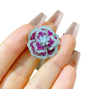 Elegant silver flower cocktail ring with red oval gemstones and sparkling white crystals