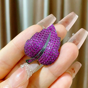Elegant leaf brooch with purple cubic zirconia and black plated metal magnetic clasp