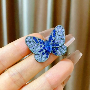 Elegant butterfly brooch featuring blue and purple crystals with a marquise-cut center stone