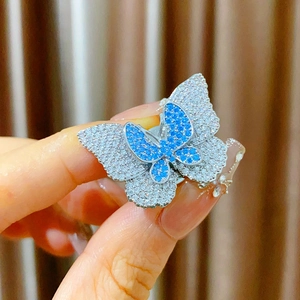 Macro shot of double-layer butterfly magnetic brooch with green and white cubic zirconia