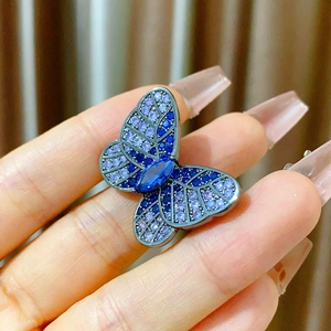 Elegant butterfly brooch featuring deep blue crystals and intricate marquise gemstone detail