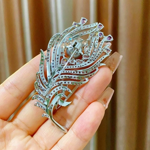 Detailed back view of a silver feather brooch showing pin clasp and hollow craftsmanship