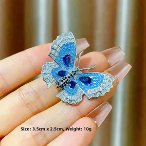 Elegant silver butterfly brooch with blue crystals and gems, size 3.5cm by 2.5cm