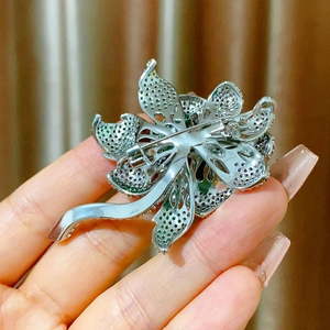 Detailed back view of purple rose brooch showing silver hollow metalwork and pin clasp