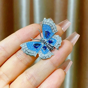 Elegant vintage butterfly brooch with blue crystals and silver metallic base