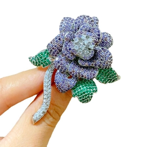 Elegant purple rose brooch with green leaf accents and sparkling cubic zirconia crystals