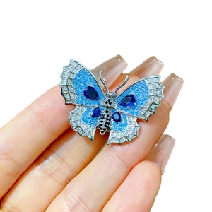 Elegant vintage butterfly brooch with blue crystals and sparkling silver wings