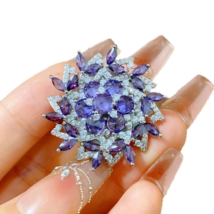 Luxurious snowflake brooch with purple zircons and white crystals for elegant suits