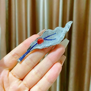 Elegant silver leaf brooch with sparkling pavé blue zircon and red ruby-like gemstone