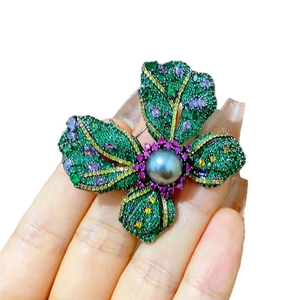 Exquisite floral brooch with multicolor crystals and a large dark grey pearl center