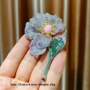 Luxurious flower brooch with pink queen shell inlay and green gemstone leaves detail