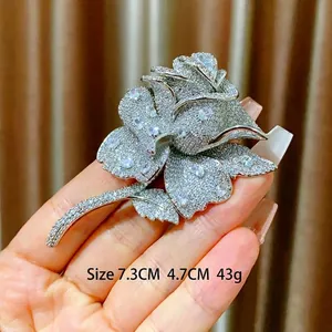 Lussuosa spilla a rosa d'argento con intarsio di cristalli e misure 7,3cm x 4,7cm
