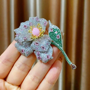 Elegant floral flower brooch with pink zircons and pearl detail on golden base