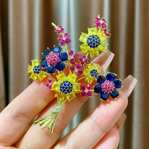 Broche bouquet de fleurs dorée de luxe avec cristaux multicolores vue à la main