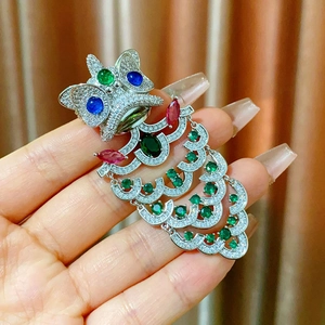 Detailed close-up of a Chinese lion dance brooch with colorful crystals and tassels