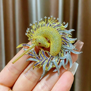 Gros plan détaillé d'une broche licorne avec placage d'or et cristaux multicolores