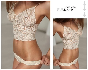 Detail of floral lace lingerie set in cream white with fine embroidery and thin straps