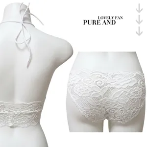 White floral lace lingerie set with halter neck bra and low-cut panties on gold mannequin
