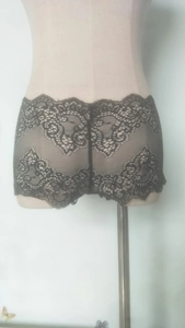 Detail of floral lace mesh pattern and eyelash trim on black women's boy-short underwear