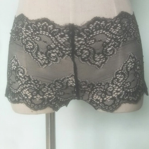Elegant black floral lace boyshorts for women featuring scalloped edges and hollow design