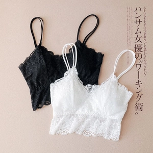 Detail of floral lace texture on black and white camisoles with delicate scalloped edges