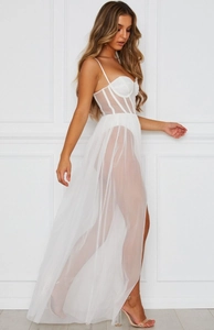 Detailed close-up of white corset bodice and layered sheer tulle skirt of a long gown