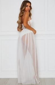 Detail of corset-style white mesh maxi dress showing thin straps and sheer layered fabric