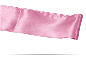 Detail of a smooth pink satin ribbon with a glossy finish for sexy eye masks or binding