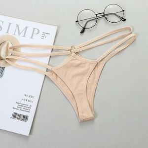 Close-up of beige T-back thong with metal ring accents and double strap waist detail