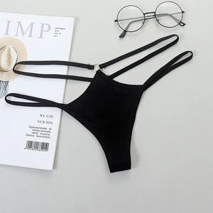 Detail of black multi-strap G-string with a golden metal ring connector on grey background