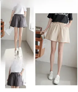 Detail of high-waist A-line shorts showing elastic drawstring and side pockets