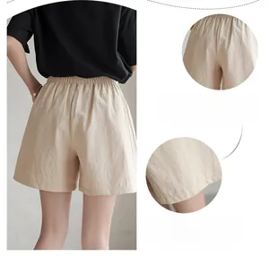 Detail of high-waist elastic waistband and breathable cotton-linen texture on khaki shorts