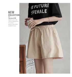 Close-up of beige linen texture shorts with elastic drawstring waist and side pockets