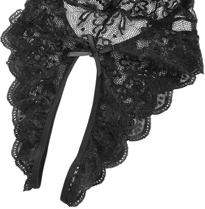 Macro detail of black floral lace fabric with a delicate ribbon bow and scalloped edges