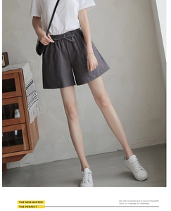 Detail of drawstring elastic waistband on gray cotton-feel loose sports shorts