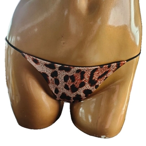 Sexy leopard print bikini bottom with double string side straps on gold mannequin
