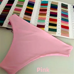 Detail of pink bikini bottoms with side straps on a colorful fabric swatch card