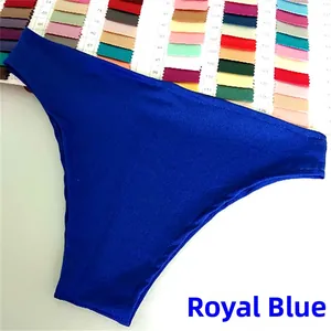 Close-up of silky dark blue bikini bottom fabric on professional textile color swatches