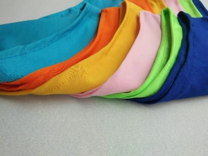 Macro shot of colorful round necklines showing precise stitching and vibrant fabric variety