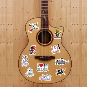 Music stickers with guitar and microphone designs on an acoustic guitar surface