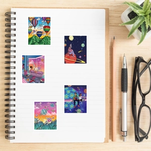Detail view of five psychedelic art stickers on a notebook with stationery on a wooden desk