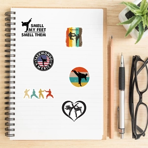 Detail of waterproof Taekwondo silhouette stickers displayed on a spiral notebook page