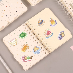 Set of 50 cute animal and food doodle stickers on a cream notebook with matte finish