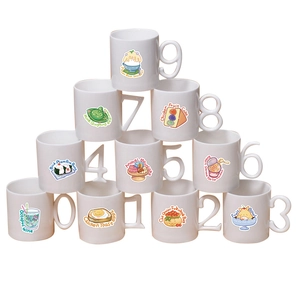 Detail of 10 ceramic mugs with number-shaped handles and cute food cartoon illustrations